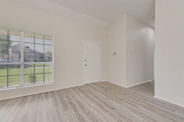 1326 Rosewood Ln, Lancaster, TX 75146 - unfurnished room featuring light wood-type flooring, vaulted ceiling, and baseboards