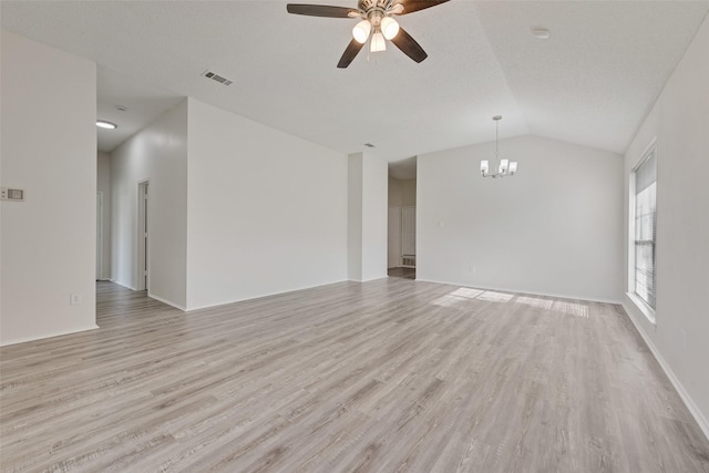 1326 Rosewood Ln, Lancaster, TX 75146 - unfurnished living room featuring a chandelier, vaulted ceiling, ceiling fan, light wood finished floors, and baseboards