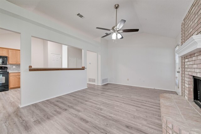 1326 Rosewood Ln, Lancaster, TX 75146 - unfurnished living room with vaulted ceiling, a fireplace, ceiling fan, and light wood-type flooring