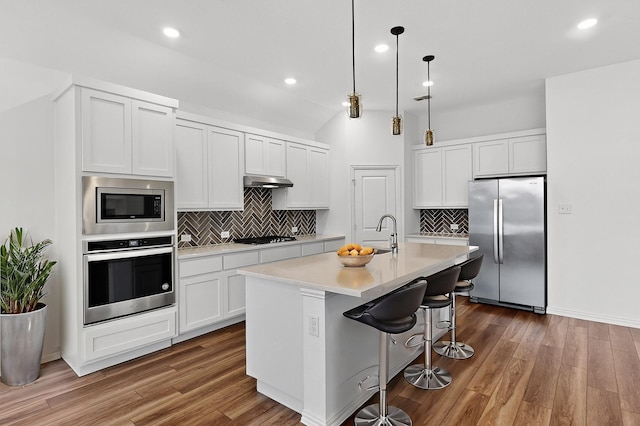 3804 Honeycomb Holw, Melissa, TX 75454 - kitchen with appliances with stainless steel finishes, light countertops, decorative backsplash, wood finished floors, and vaulted ceiling