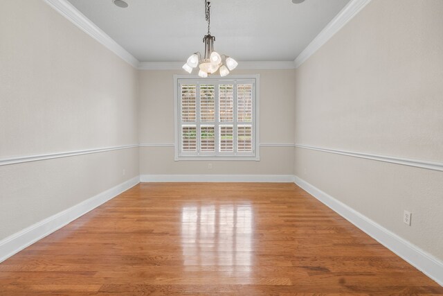 504 Hilltop Pl, Joshua, TX 76058 - empty room featuring a chandelier, crown molding, wood finished floors, and baseboards