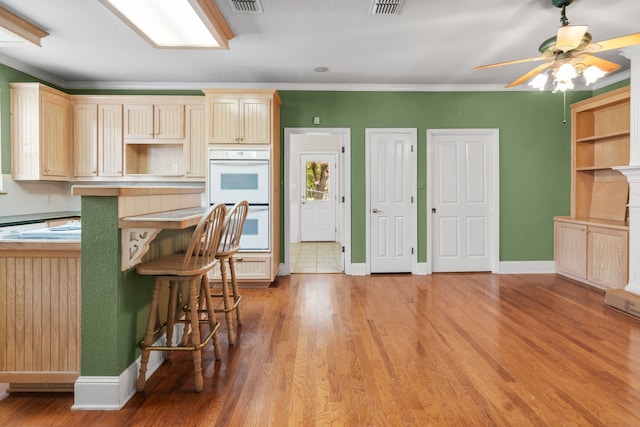 504 Hilltop Pl, Joshua, TX 76058 - kitchen with double oven, light wood-type flooring, a ceiling fan, baseboards, and ornamental molding