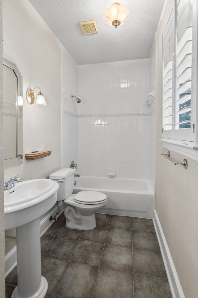 504 Hilltop Pl, Joshua, TX 76058 - bathroom featuring toilet, baseboards, a textured ceiling, bathtub / shower combination, and tile patterned flooring