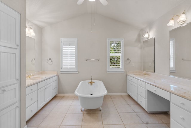 504 Hilltop Pl, Joshua, TX 76058 - bathroom with two vanities, a freestanding tub, baseboards, and lofted ceiling