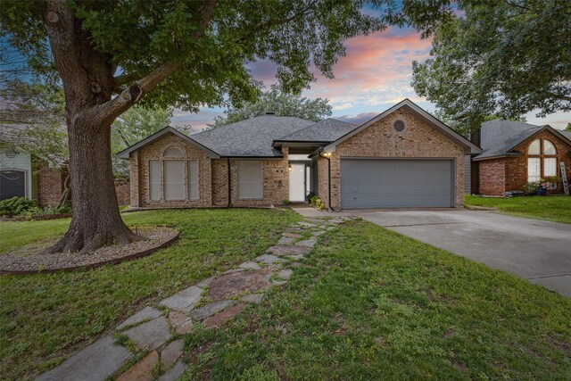143 Westwood Dr, Rockwall, TX 75032 - view of front of home featuring a garage, concrete driveway, a front yard, and brick siding