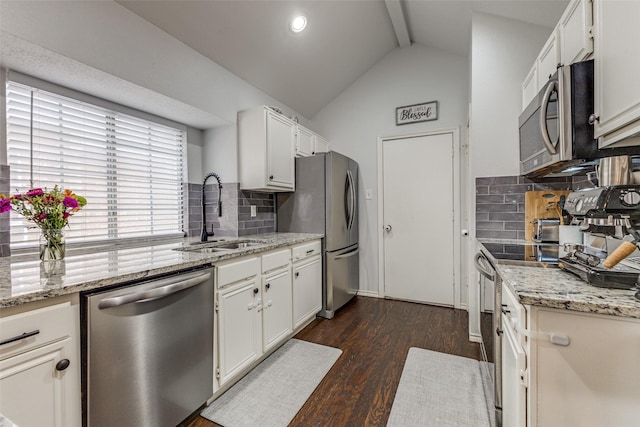 143 Westwood Dr, Rockwall, TX 75032 - kitchen with appliances with stainless steel finishes, a sink, decorative backsplash, dark wood-style floors, and vaulted ceiling