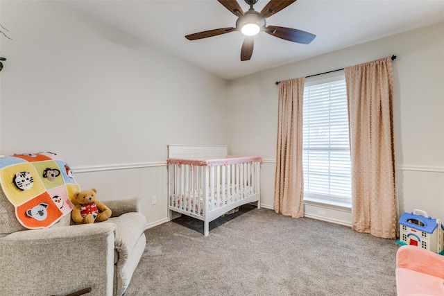 143 Westwood Dr, Rockwall, TX 75032 - carpeted bedroom featuring a crib, multiple windows, a ceiling fan, and baseboards