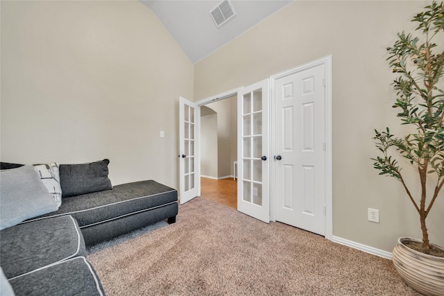 583 Louder Way, Fate, TX 75087 - living area featuring french doors, carpet, baseboards, arched walkways, and high vaulted ceiling