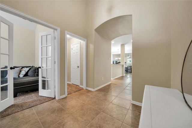 583 Louder Way, Fate, TX 75087 - hallway with french doors, baseboards, tile patterned floors, and a high ceiling