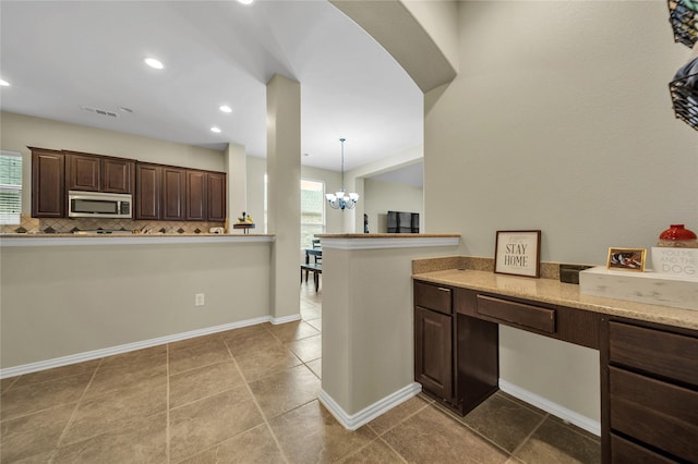 583 Louder Way, Fate, TX 75087 - kitchen featuring stainless steel microwave, dark brown cabinets, a chandelier, baseboards, and light tile patterned flooring