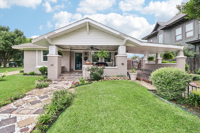 2704 Travis Ave, Fort Worth, TX 76110 - view of front facade with a porch, brick siding, and ceiling fan