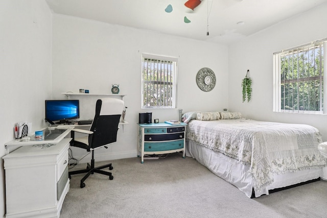 2704 Travis Ave, Fort Worth, TX 76110 - bedroom featuring light colored carpet, multiple windows, an office area, and ceiling fan
