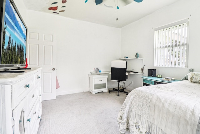 2704 Travis Ave, Fort Worth, TX 76110 - bedroom with light carpet, a desk, a ceiling fan, and baseboards