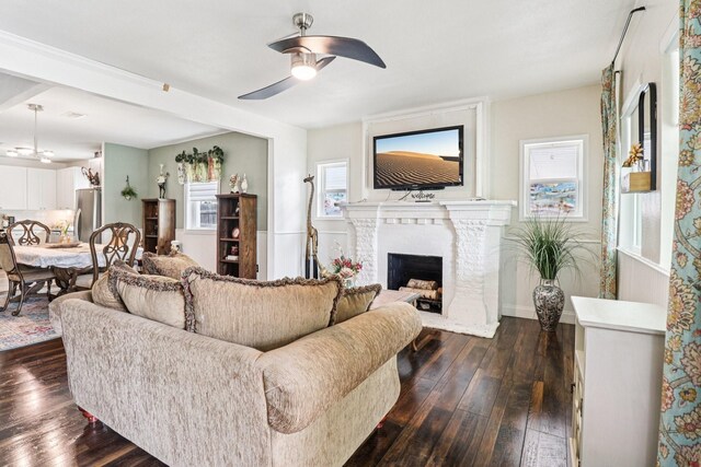 2704 Travis Ave, Fort Worth, TX 76110 - living room featuring a ceiling fan, dark wood-type flooring, and a brick fireplace