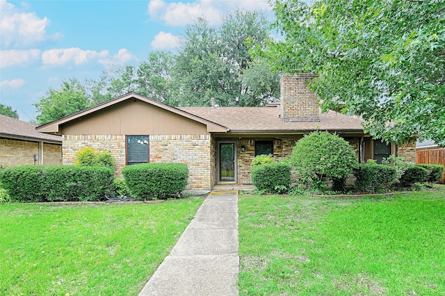 614 Brookfield Dr, Garland, TX 75040 - view of front of home with a chimney, a front lawn, and brick siding