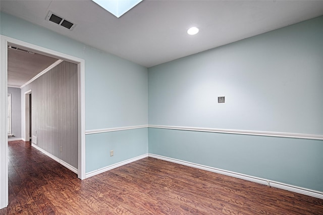 614 Brookfield Dr, Garland, TX 75040 - unfurnished room featuring wood finished floors, baseboards, a skylight, ornamental molding, and recessed lighting