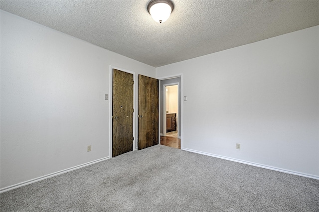 614 Brookfield Dr, Garland, TX 75040 - unfurnished bedroom featuring carpet flooring, baseboards, and a textured ceiling