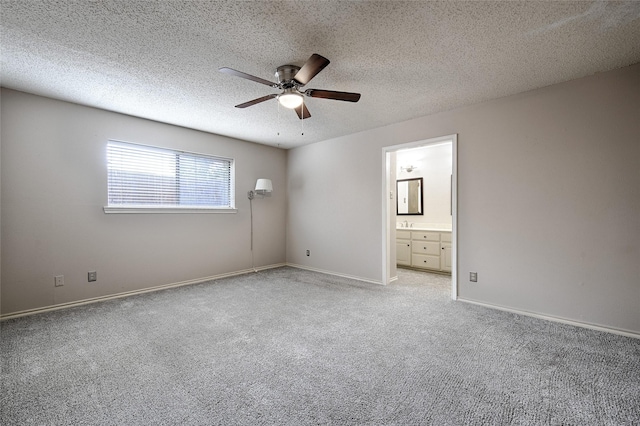 614 Brookfield Dr, Garland, TX 75040 - unfurnished bedroom with light carpet, a textured ceiling, connected bathroom, ceiling fan, and baseboards
