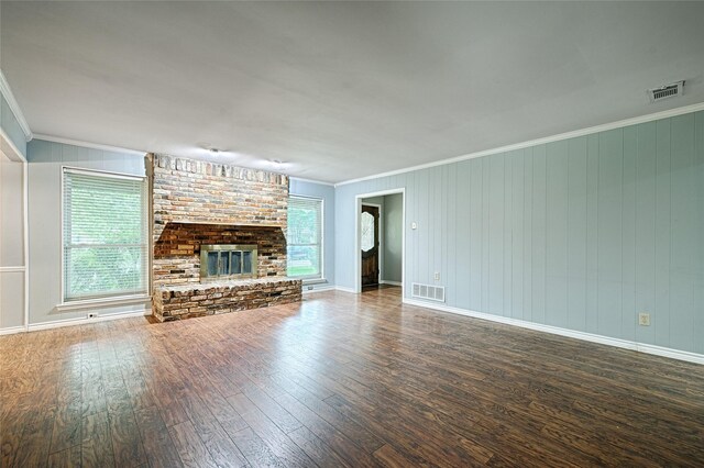 614 Brookfield Dr, Garland, TX 75040 - unfurnished living room with wood-type flooring, crown molding, a fireplace, and baseboards
