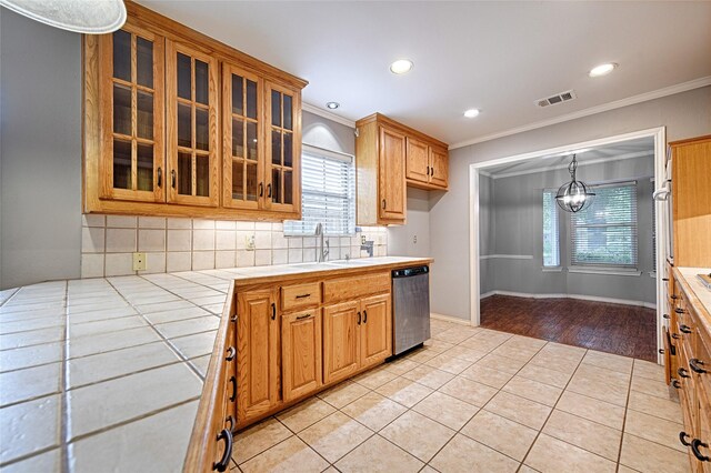 614 Brookfield Dr, Garland, TX 75040 - kitchen featuring ornamental molding, dishwasher, tile countertops, a sink, and plenty of natural light