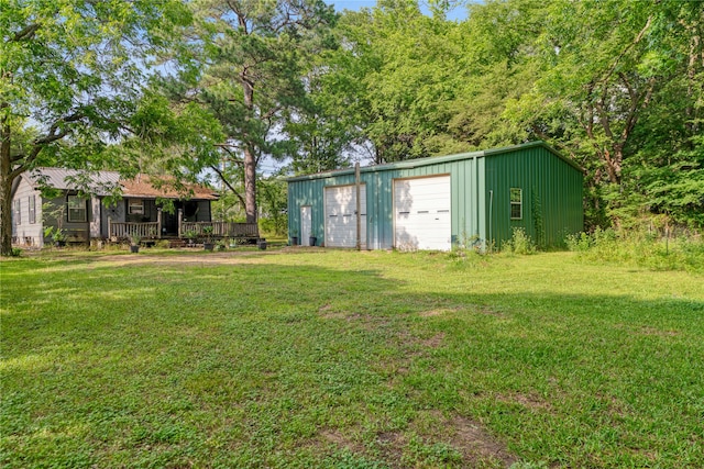 5990 Lamar Rd, Reno, TX 75462 - view of green lawn with an outbuilding and a detached garage