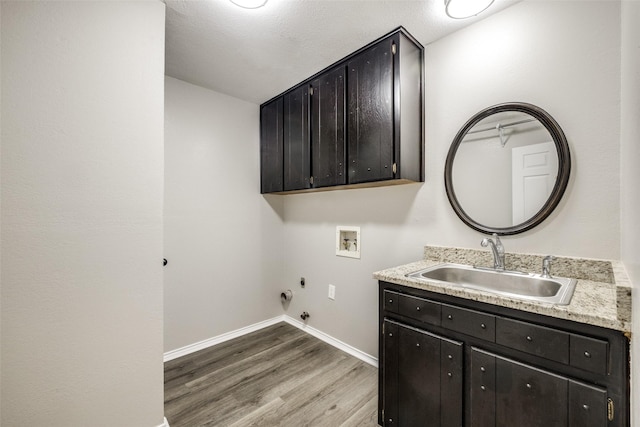 101 Circleview Dr S, Hurst, TX 76054 - laundry room with hookup for a washing machine, cabinet space, light wood-style flooring, gas dryer hookup, and baseboards
