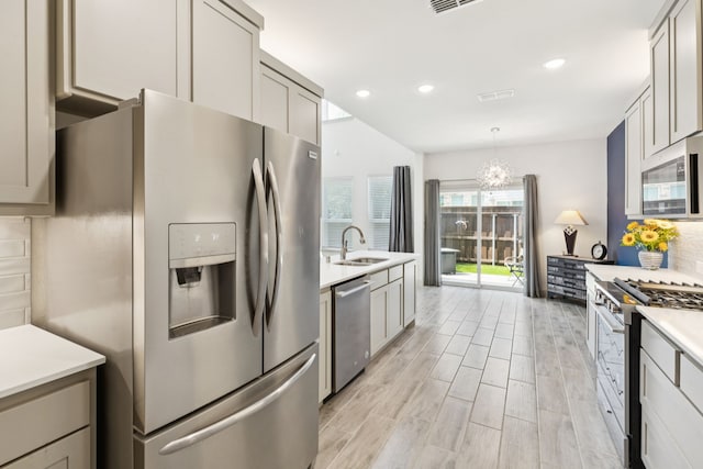984 Mikaela Dr, Allen, TX 75013 - kitchen featuring stainless steel appliances, a sink, light countertops, decorative backsplash, and recessed lighting