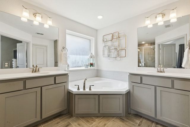 984 Mikaela Dr, Allen, TX 75013 - full bathroom featuring a stall shower, two vanities, a garden tub, and recessed lighting