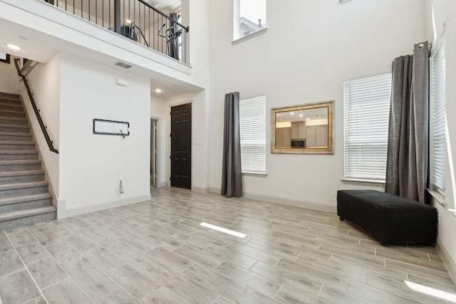984 Mikaela Dr, Allen, TX 75013 - unfurnished living room with stairs, baseboards, and a towering ceiling