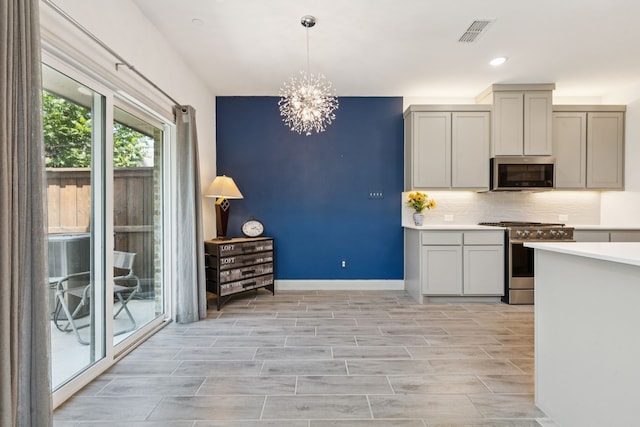984 Mikaela Dr, Allen, TX 75013 - kitchen with stainless steel appliances, backsplash, a chandelier, light countertops, and pendant lighting