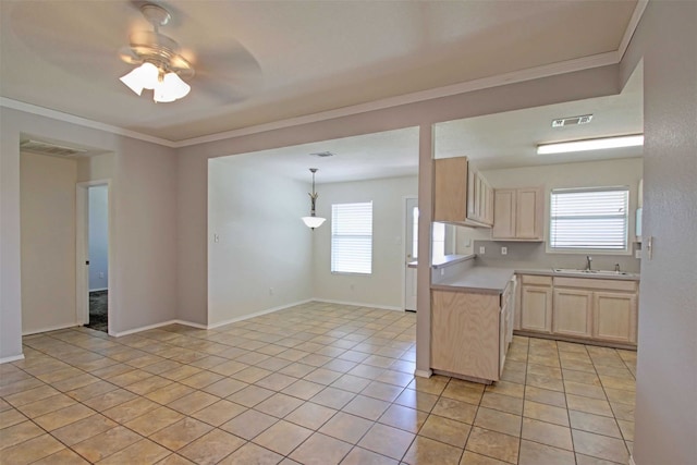 1103 Lynnwood Ct, Cleburne, TX 76033 - kitchen featuring a sink, light countertops, light brown cabinetry, light tile patterned floors, and crown molding