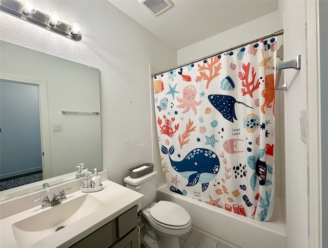 10029 Denali Dr, Little Elm, TX 75068 - bathroom with vanity, toilet, shower / tub combo, tile patterned floors, and a textured wall