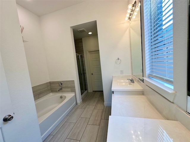 10029 Denali Dr, Little Elm, TX 75068 - bathroom with a garden tub, double vanity, and a stall shower