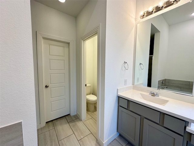 10029 Denali Dr, Little Elm, TX 75068 - bathroom featuring vanity, toilet, and a textured wall