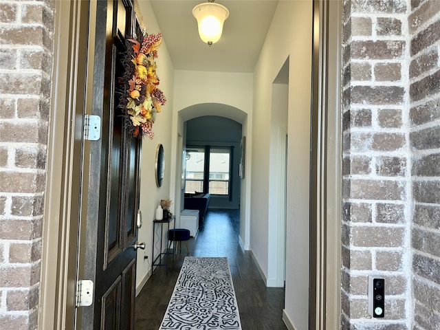 10029 Denali Dr, Little Elm, TX 75068 - hall with arched walkways, dark wood-type flooring, and baseboards