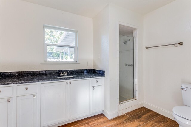 4704 S Drive, Fort Worth, TX 76109 - full bathroom featuring toilet, a stall shower, wood finished floors, vanity, and baseboards