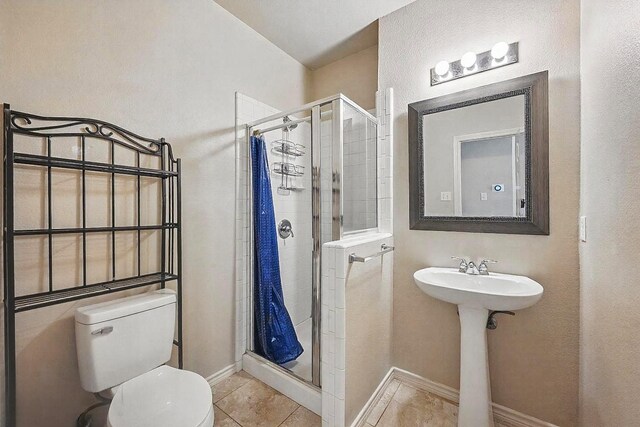 315 Hudson Falls Dr, Arlington, TX 76002 - full bathroom featuring a shower stall, toilet, tile patterned floors, and baseboards