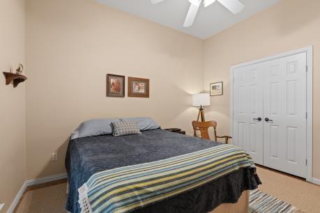 240 Lakeside Oaks Cir, Lakeside, TX 76135 - bedroom with light colored carpet, a ceiling fan, and baseboards