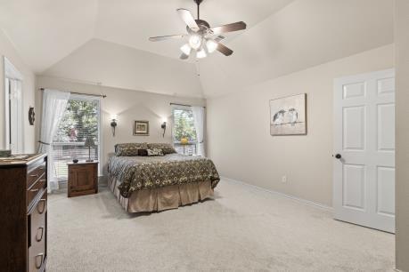 240 Lakeside Oaks Cir, Lakeside, TX 76135 - bedroom with lofted ceiling, light colored carpet, multiple windows, and ceiling fan