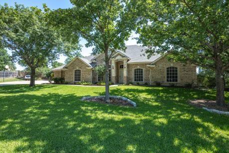 240 Lakeside Oaks Cir, Lakeside, TX 76135 - view of front of property with a front yard and stone siding