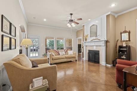 240 Lakeside Oaks Cir, Lakeside, TX 76135 - living room featuring crown molding, a ceiling fan, a fireplace, recessed lighting, and concrete flooring