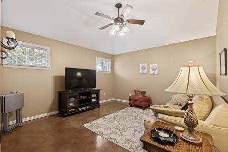 240 Lakeside Oaks Cir, Lakeside, TX 76135 - living room with a ceiling fan, baseboards, and concrete floors