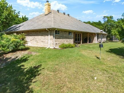240 Lakeside Oaks Cir, Lakeside, TX 76135 - rear view of house featuring a chimney and a lawn