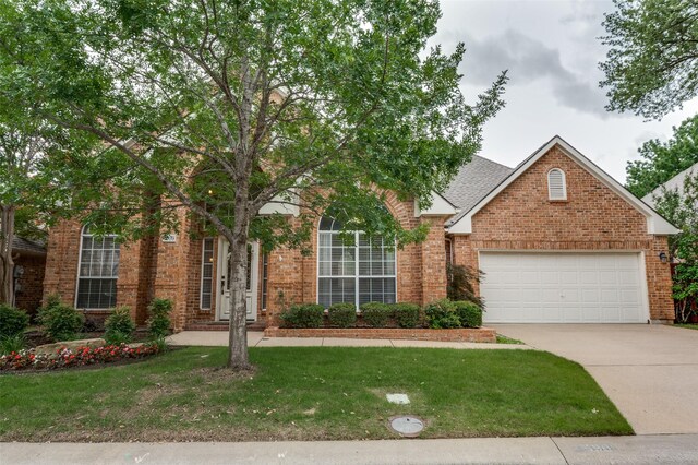 5909 La Cumbre Dr, Mckinney, TX 75072 - view of front of property with brick siding, a front yard, driveway, and a garage