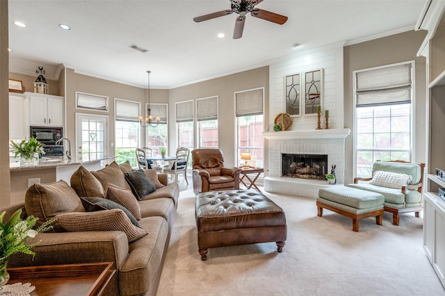 5909 La Cumbre Dr, Mckinney, TX 75072 - living room featuring carpet floors, a chandelier, plenty of natural light, ceiling fan, and crown molding