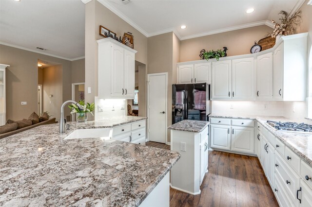 5909 La Cumbre Dr, Mckinney, TX 75072 - kitchen with black fridge with ice dispenser, stainless steel gas cooktop, dark wood-style floors, a sink, and light stone counters