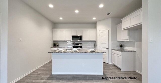2006 Iris, Melissa, TX 75454 - kitchen featuring appliances with stainless steel finishes, dark stone counters, tasteful backsplash, recessed lighting, and wood tiled floors