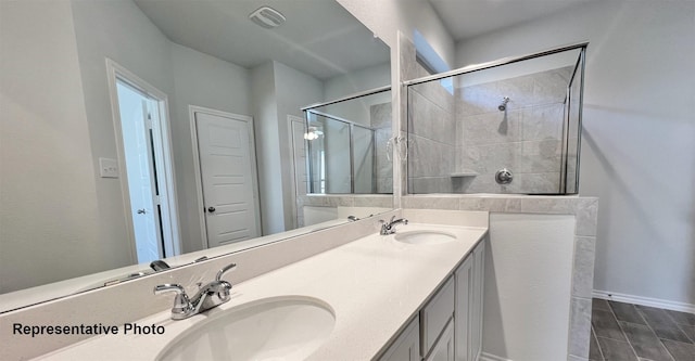 2006 Iris, Melissa, TX 75454 - bathroom with double vanity, a tile shower, and baseboards