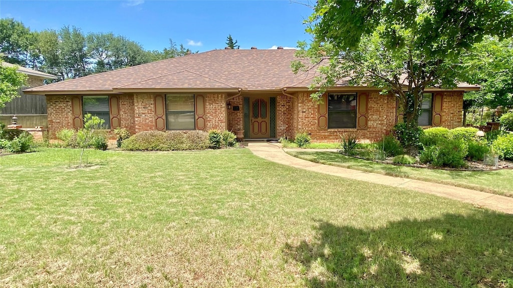 221 Lamesa Dr, Highland Village, TX 75077 - view of front of home with brick siding, a front lawn, and roof with shingles