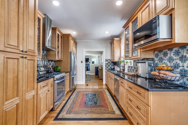 2220 Mistletoe Blvd, Fort Worth, TX 76110 - kitchen with stainless steel appliances, recessed lighting, wall chimney exhaust hood, tasteful backsplash, and dark stone countertops